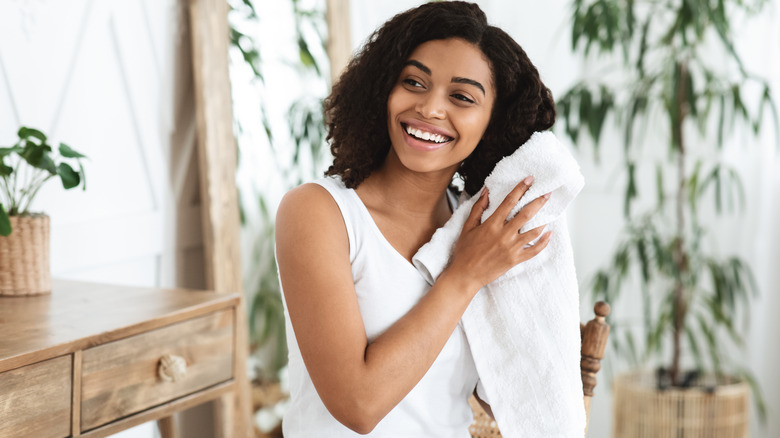Woman drying hair with towel