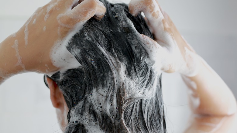 Woman shampooing hair