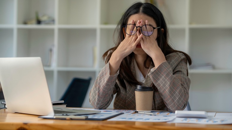 Unhappy woman at work desk