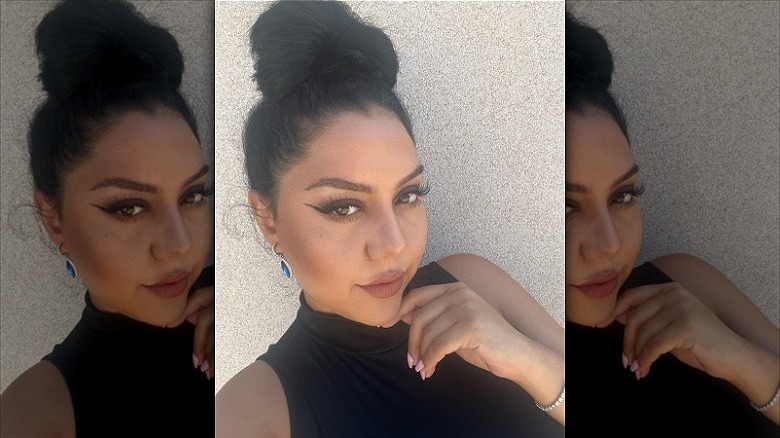 woman wearing hair in floppy top knot