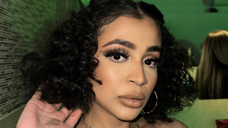 A woman with a curly lob