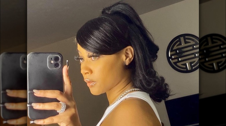 A woman with a half updo lob