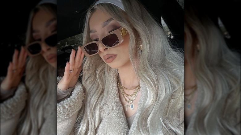 Woman wearing sunglasses with logo