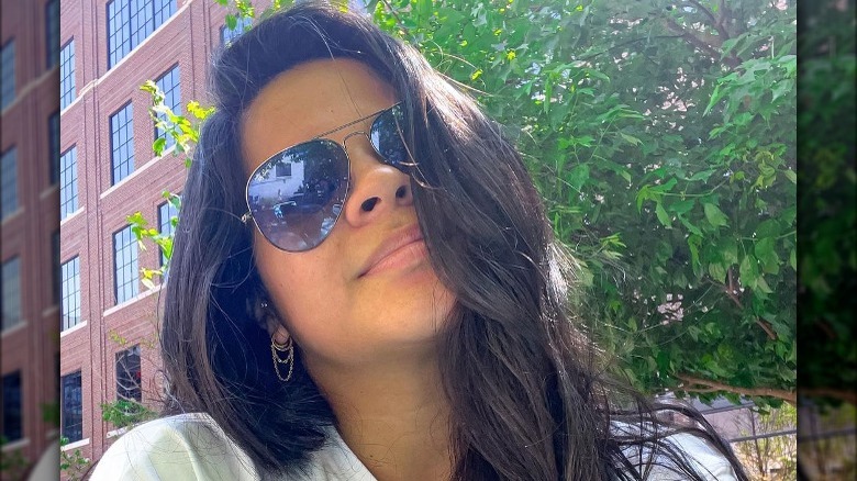 Woman wearing dainty chain earrings