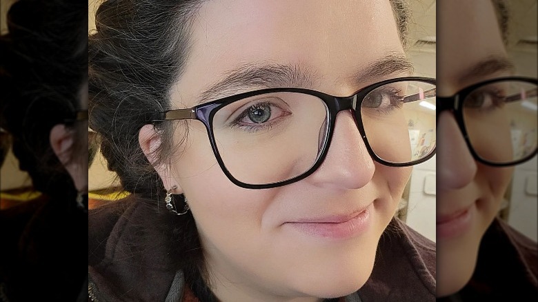 Woman wearing small floral hoops