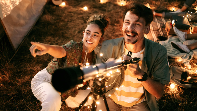 Couple looking through telescope