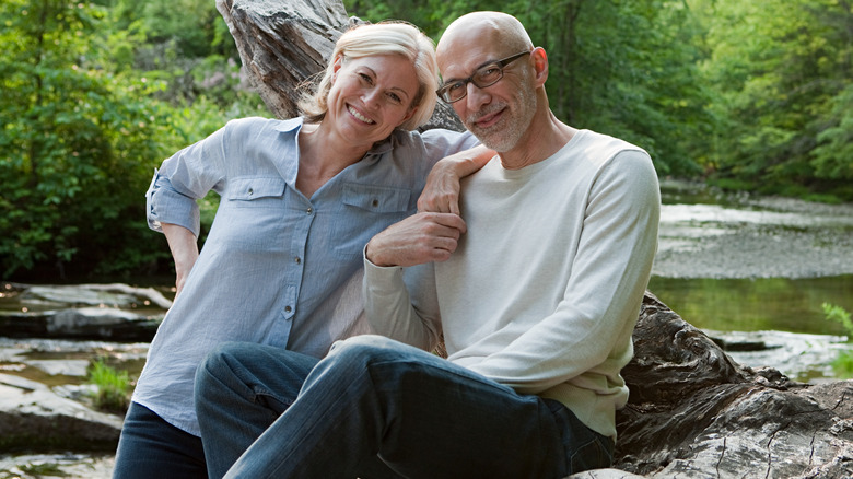 Mature couple posing outside