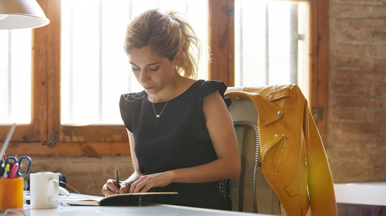 Woman writing in notebook