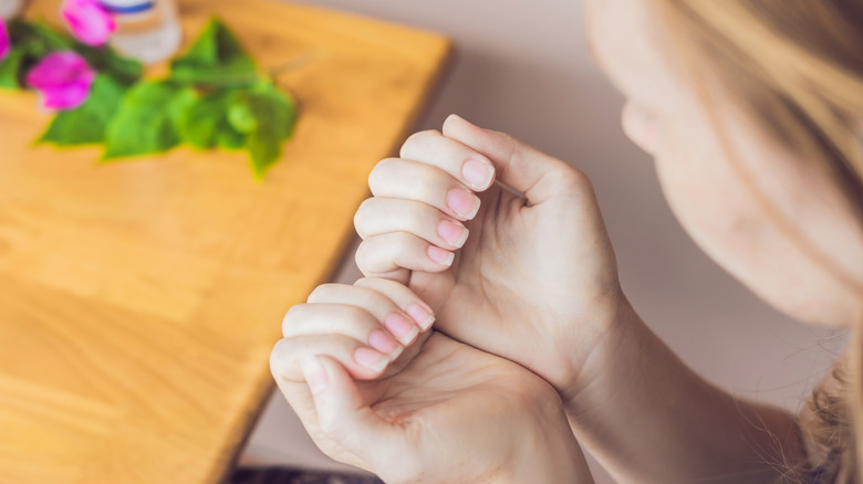 Woman looking at her nails