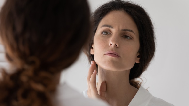 Woman examining her face