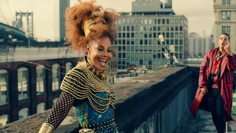 Janet Jackson wearing a blue-and-black outfit with gold detailing