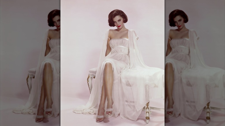 Natalie Wood poses in a long white gown.
