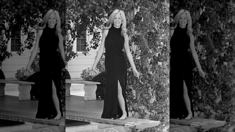 Farrah Fawcett wears a black turtleneck maxi dress
