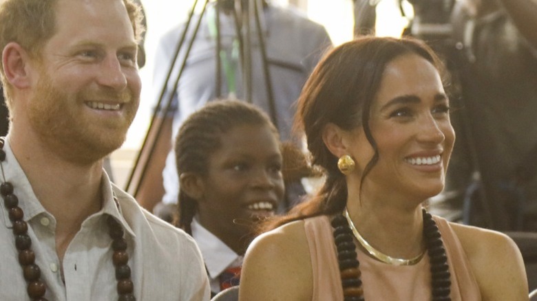 Prince Harry and Meghan Markle watch a student performance in Nigeria