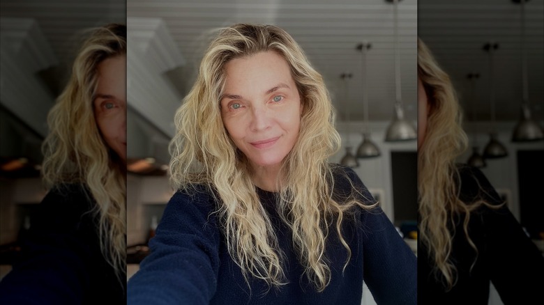 Michelle Pfeiffer wearing a black sweater and no makeup
