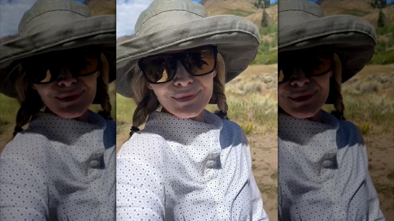 Michelle Pfeiffer wears a sun hat, sunglasses, and no makeup while outside