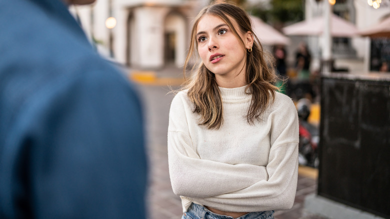 Irritated woman listening to man