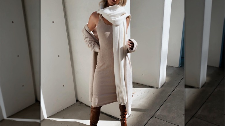 Woman wearing dress, oversized scarf