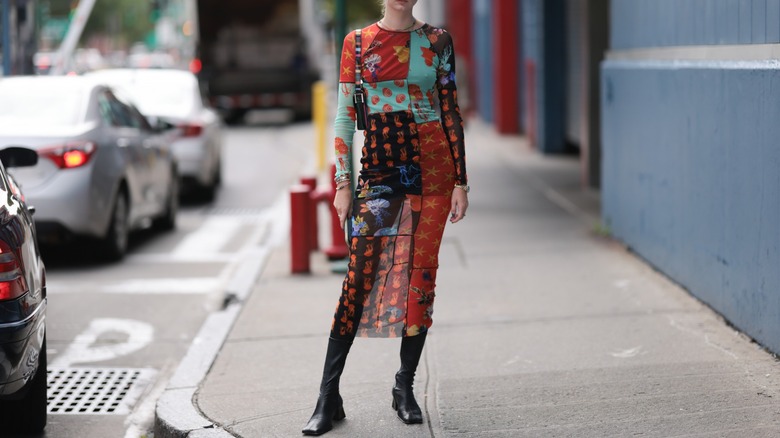Woman wearing dress, tall boots