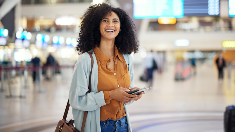 Woman at airport smiling