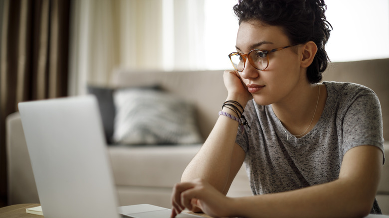 Woman researches on laptop 