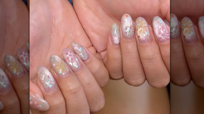 Iridescent nails with firework designs.