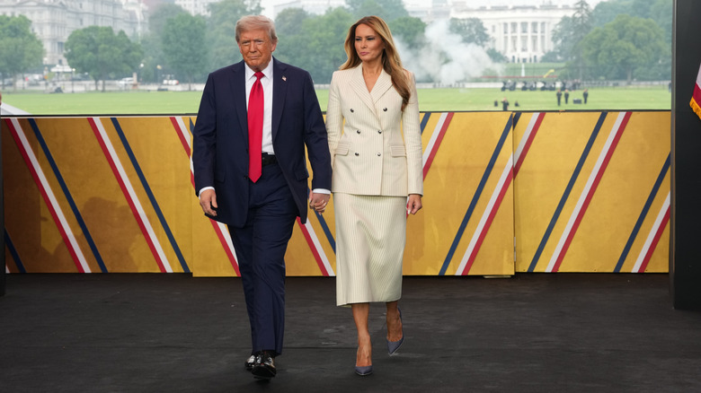 President Donald Trump and First Lady Melania Trump walk on stage during a celebration of the Army's 250th birthday on the National Mall on June 14, 2025 in Washington, DC (2025)