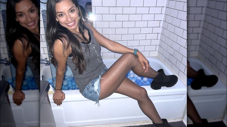 Woman poses in distress denim shorts