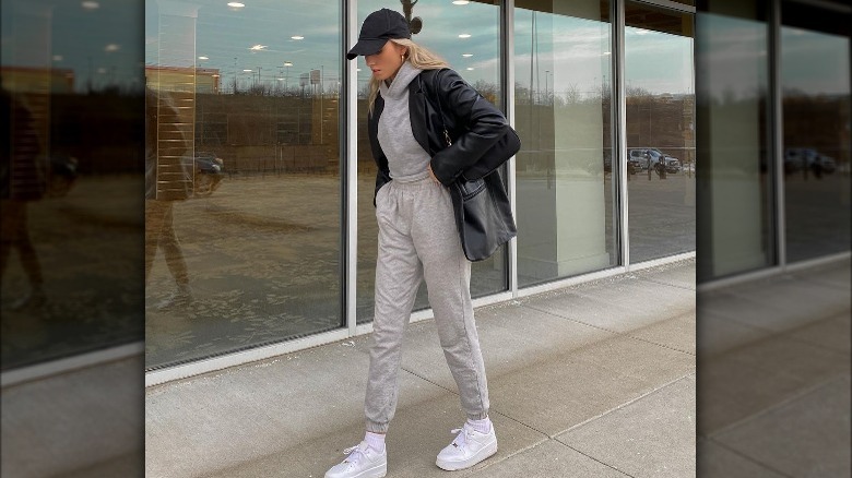 Woman walks down street in joggers