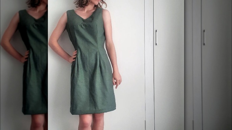 Woman poses in sheath dress