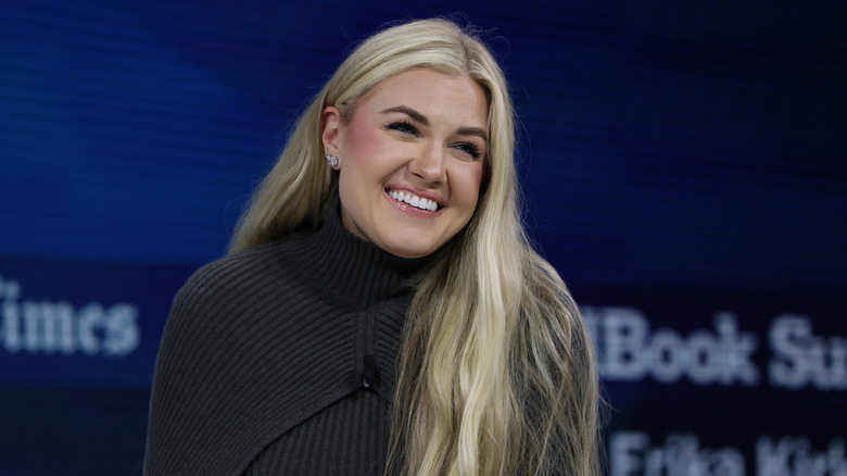 Erika Kirk smiling on stage during the  New York Times DealBook Summit