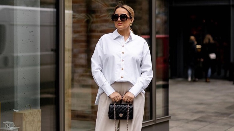 Woman holding top handle bag