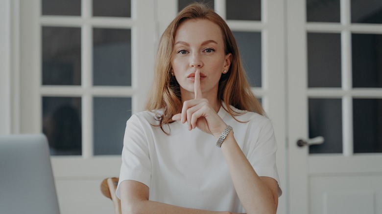 Woman doing "shh" gesture