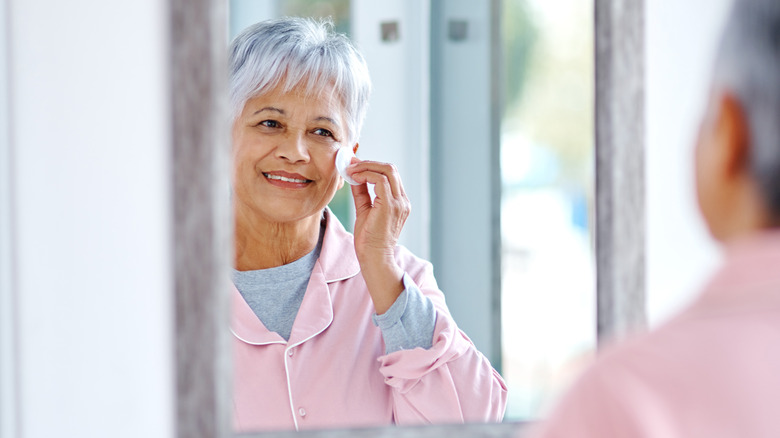 Woman applying skincare products
