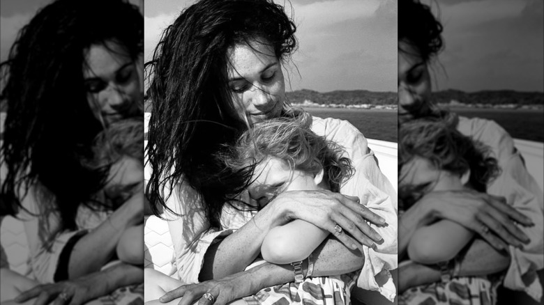 Meghan Markle hugs Lilibet on the beach.