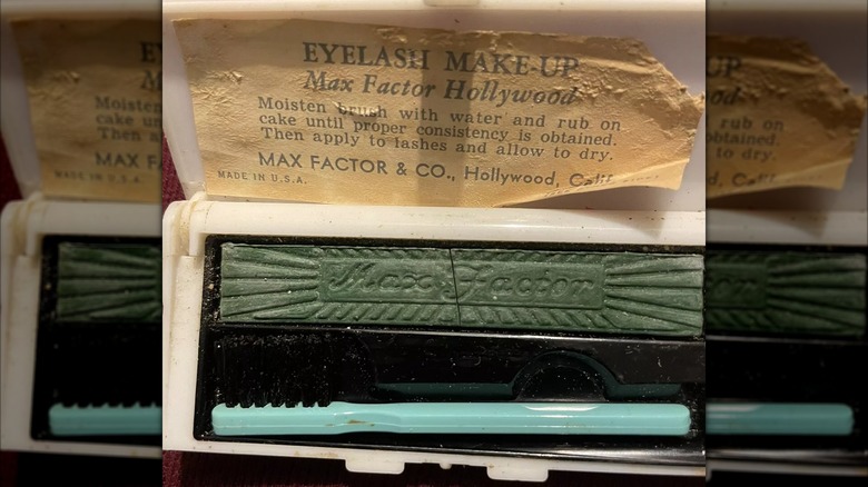 A green cake mascara with a brush