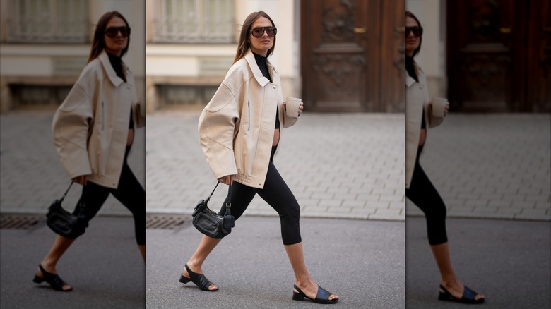 Ariel Winter walks down the street in capri leggings