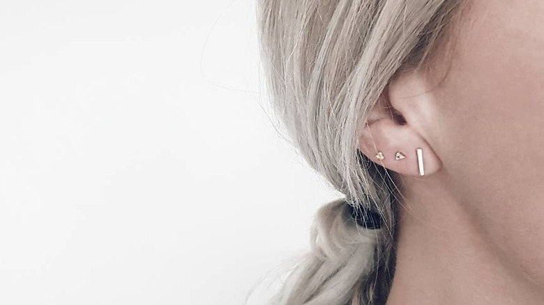 Woman wearing gold dainty earrings