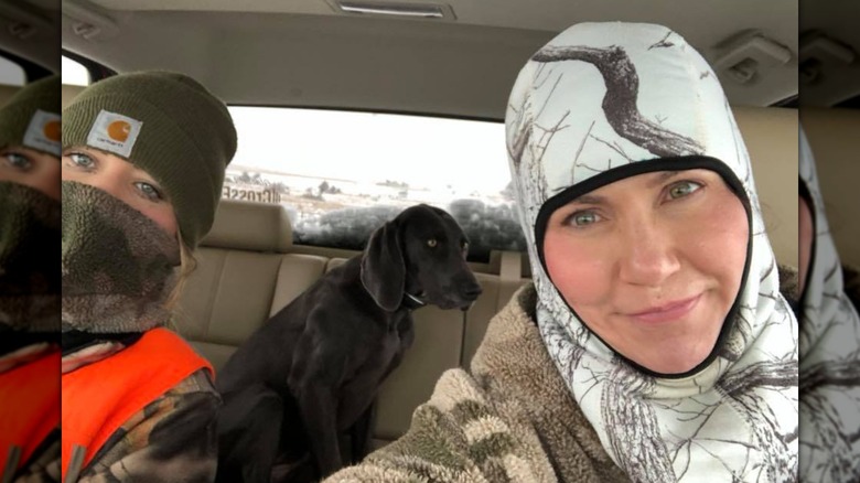 Kristi Noem taking a selfie in her car with her daughter and her dog