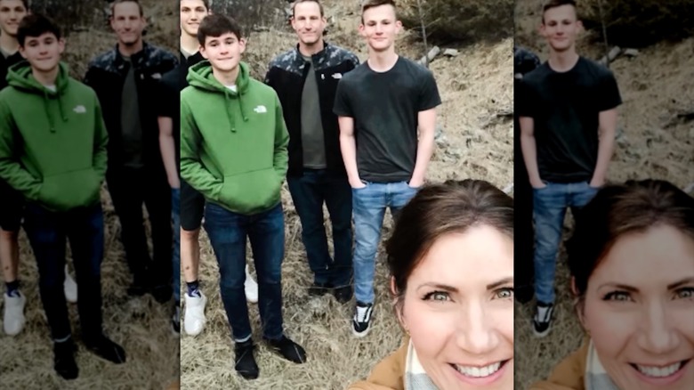 Kristi Noem taking a selfie outdoors with little makeup