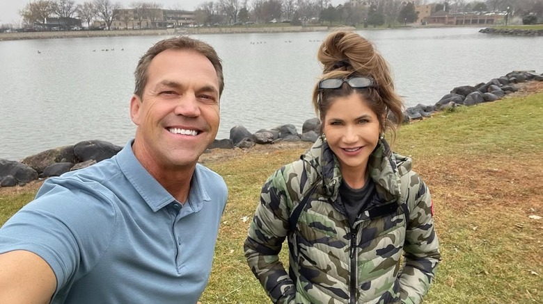 Bryon and Kristi Noem taking a selfie in front of a lake