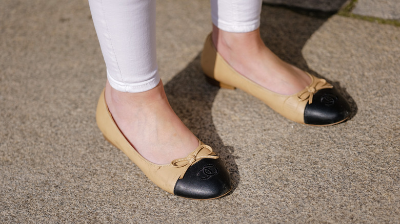 Closeup of beige/black ballet flats