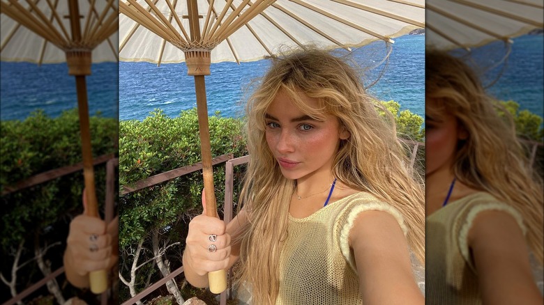 Sabrina Carpenter taking beach selfie