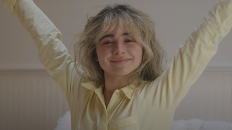 Sabrina Carpenter stretching in yellow