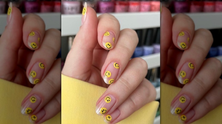 Close up view of a smiley face manicure.