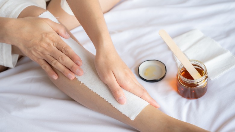Cold wax strip on a woman's leg