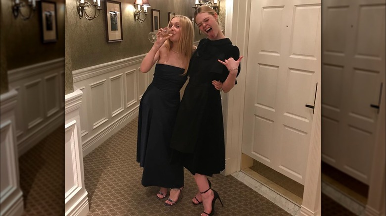 Dakota and Elle Fanning wear similar dresses and pose together