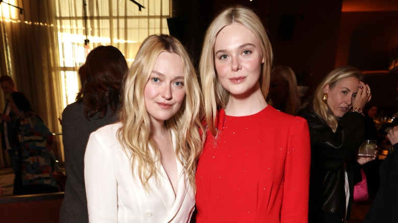 Dakota Fanning and Elle Fanning pose together.
