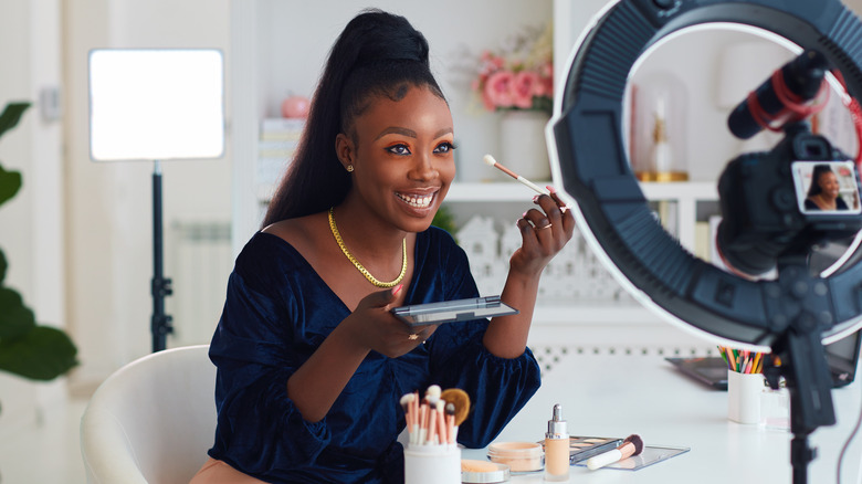 A woman applying eyeshadow