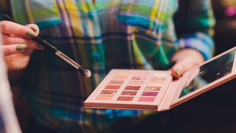 A woman applying eyeshadow
